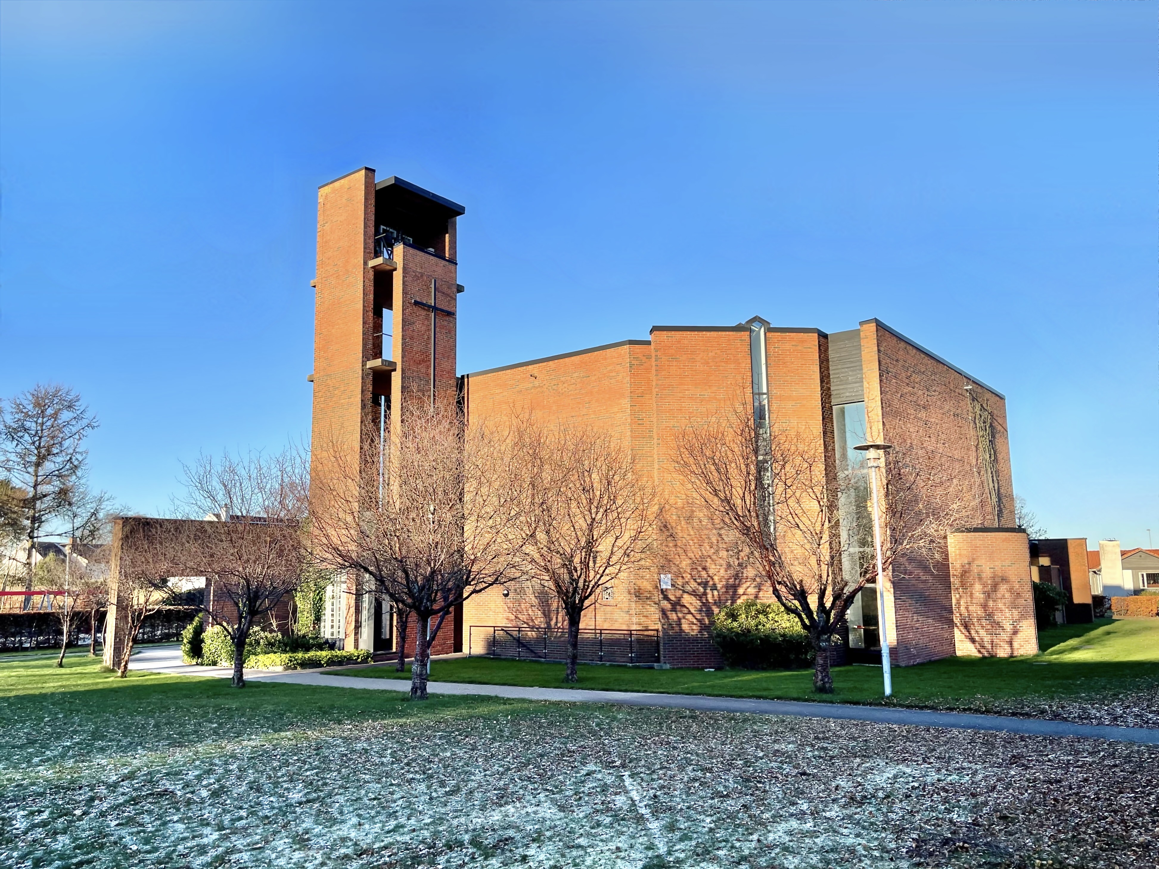 Stokka kirke on punaruskea, tiilestä rakennettu moderni rakennus.