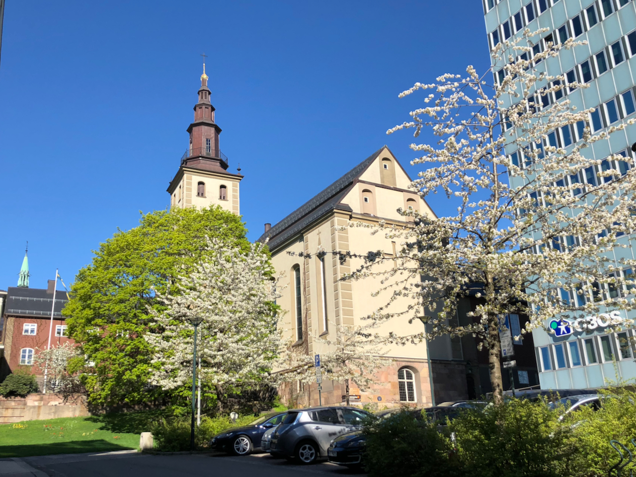 Oslon Margareta-kirkko kevättalvella. Kirkas taivas ja lehdetön kirsikkapuu.